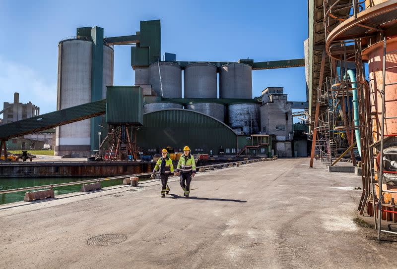 Workers walk at Cementa's Slite plant in Slite