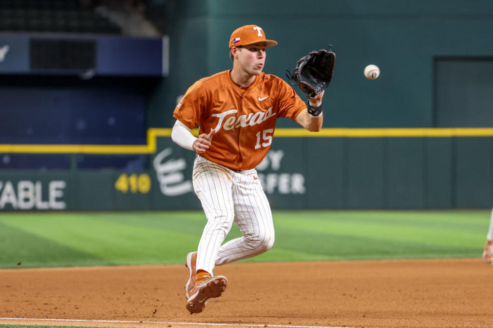 ARLINGTON, TX – MAY 22: Texas catcher Peyton Powell (15) fields a ground ball during the 2024 Phillips 66 Big 12 Baseball Championship game between Texas and Cincinnati on May 22, 2024, at Globe Life Field in Arlington, TX. (Photo by David Buono/Icon Sportswire via Getty Images)