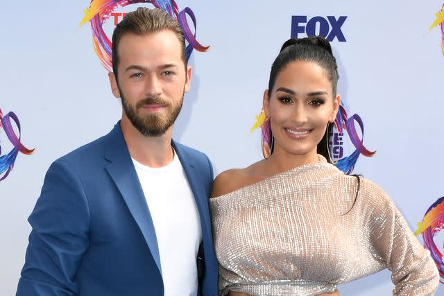 <p>Jon Kopaloff/FilmMagic</p> Artem Chigvintsev (L) and Nikki Bella attend FOX's Teen Choice Awards 2019 on August 11, 2019 in Hermosa Beach, California.