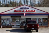 FILE PHOTO: Signs cover the front of the 619DW Guns and Ammo store in Merrimack