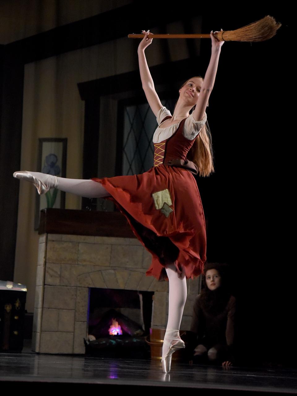 Evelyn Short, 18, splitting the role of Cinderella with Elora Russell, 17, above dances in Act 1 at her home, behind Lacey Palmer, who's splitting the role of the cat with Cora Woisniewski, in the River Raisin Ballet Company's production of "Cinderella" at the River Raisin for the Arts.