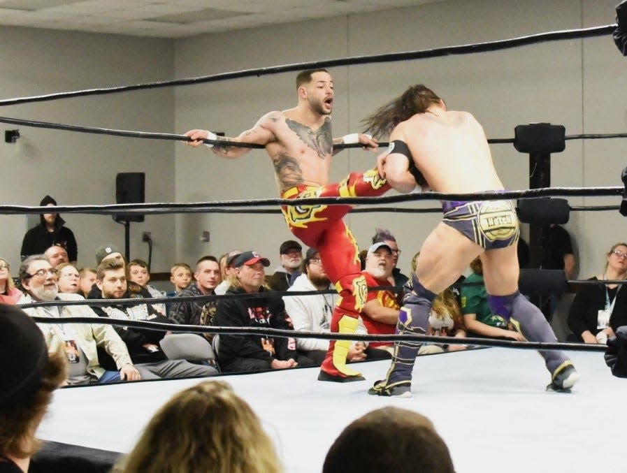 Professional wrestler Trey Miguel kicks Top Notch Jason Hotch during Insane Wrestling Revolution’s event at the Ottawa County Fairgrounds. About 300 people of all ages attended the first event in Ottawa County.