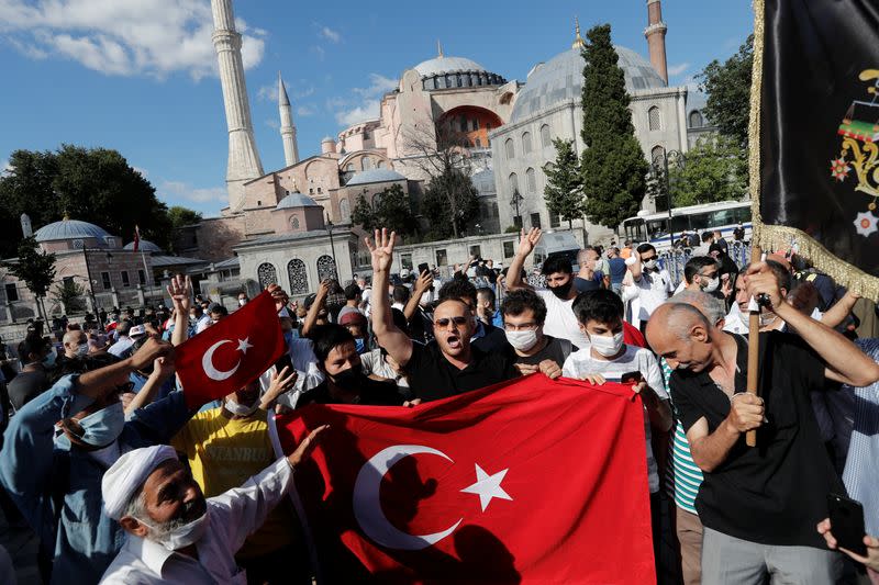 People gather in front of the Hagia Sophia or Ayasofya, after a court decision that paves the way for it to be converted from a museum back into a mosque, in Istanbul