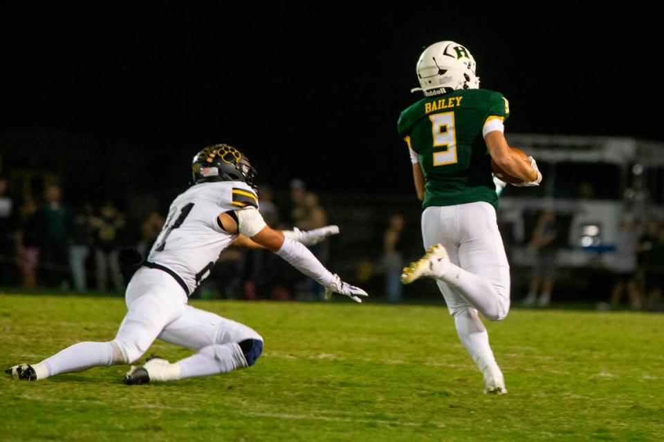 Caden Bailey, 9, of Hilmar High breaks free from Hughson defensive line for a 71 yard touchdown run during one quarter Friday Oct. 20, 2023 at Hilmar.