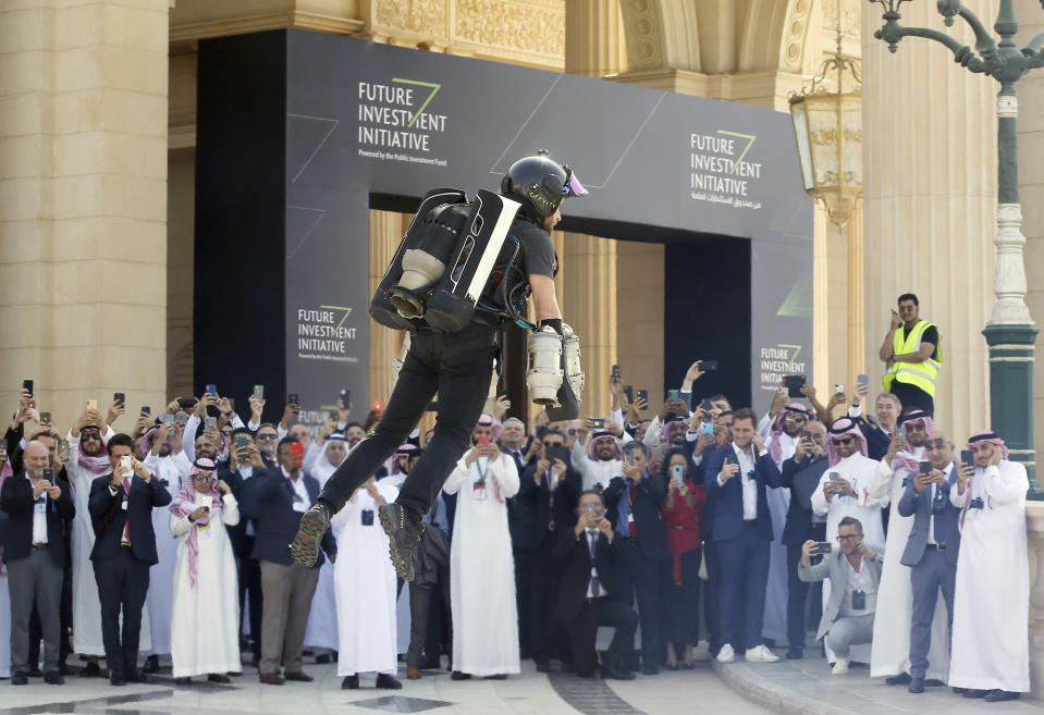 British inventor Richard Browning uses a jet pack to display his technology at the Future Investment Initiative forum in Riyadh, Saudi Arabia, Tuesday, Oct. 29, 2019. The long-planned initial public offering of a sliver of Saudi Arabia's state-run oil giant Saudi Aramco will see shares traded on Riyadh's stock exchange in December, a Saudi-owned satellite news channel reported Tuesday as the kingdom's marquee investment forum got underway. (AP Photo/Amr Nabil)