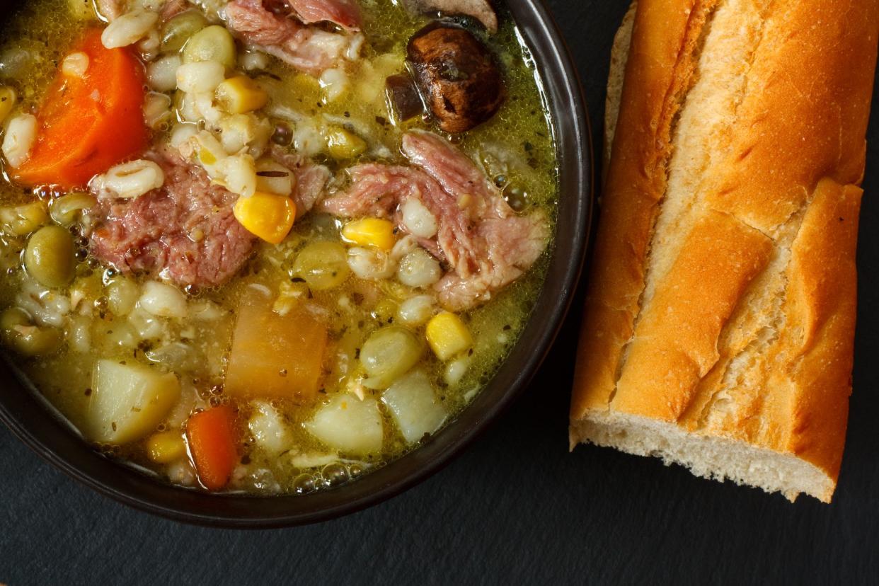 Bowl of ham stew with crusty bread