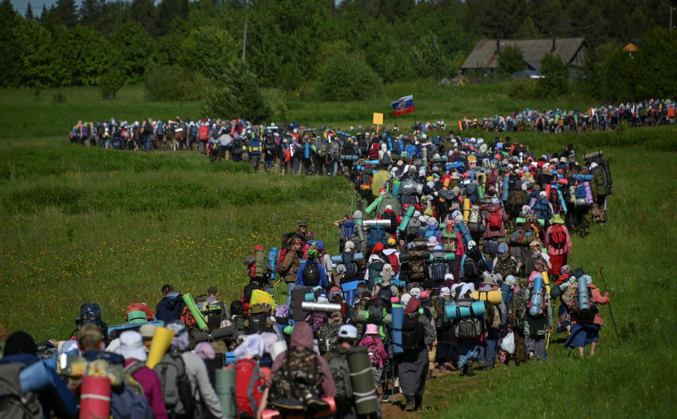 Orthodox believers go on pilgrimage celebrating the icon of St. Nicholas in Kirov Region, Russia June 4, 2021. At least 17 thousand pilgrims, loaded with backpacks and some of them barefoot, took part in a five-day and 150-kilometer-long journey from Kirov to the village of Velikoretskoye, according to the local media. Picture taken June 4, 2021. REUTERS/Alexey Malgavko     TPX IMAGES OF THE DAY