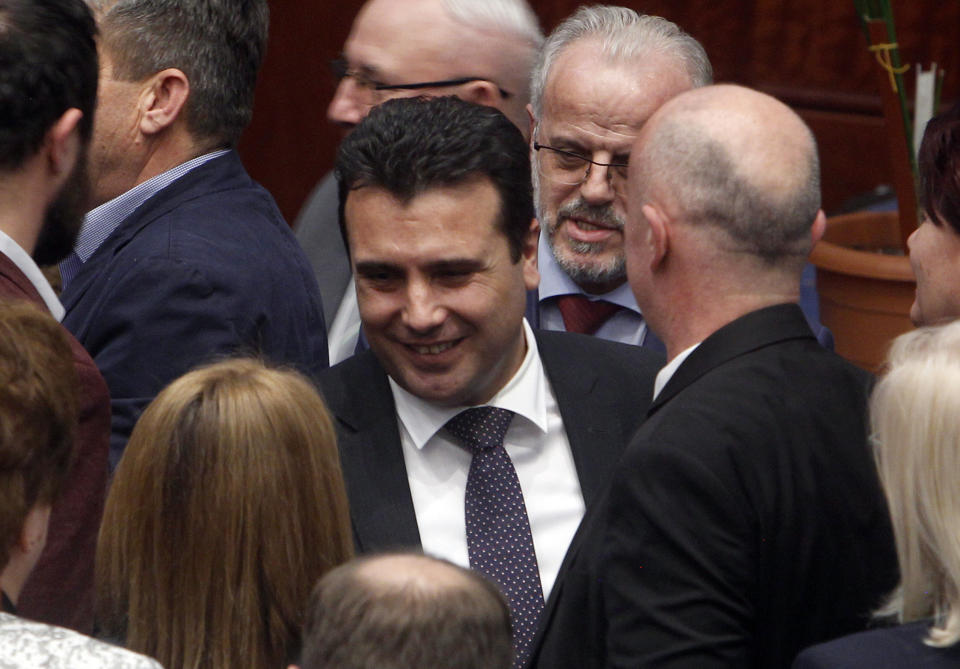 Macedonian Prime Minister Zoran Zaev, center, is greeted by lawmakers after the parliament voted in favor of the constitutional changes, in Macedonian Parliament in the capital Skopje, Friday, Jan. 11, 2019. Macedonia has fulfilled its part of a deal that will pave its way to NATO membership and normalize relations with neighboring Greece, after lawmakers approved constitutional changes that will rename the country North Macedonia. (AP Photo/Boris Grdanoski)