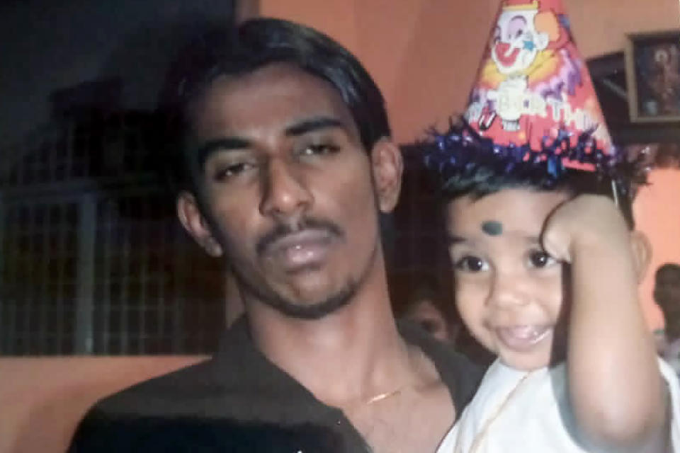 FILE - This undated photo provided by Sarmila Dharmalingam, shows her younger brother Nagaenthran K.Dharmalingam holding his nephew in Ipoh, Malaysia. Singapore's High Court on Monday, Nov. 8, 2021, halted the imminent execution of Nagaenthran, believed to be mentally disabled, amid pleas from the international community and rights groups. (Sarmila Dharmalingam via AP, File)