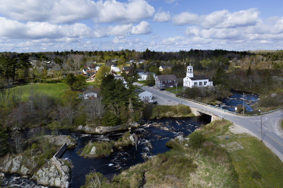 The Pleasant River flows through Columbia Falls, Maine, Thursday, April 27, 2023. (AP Photo/Rodrique Ngowi)