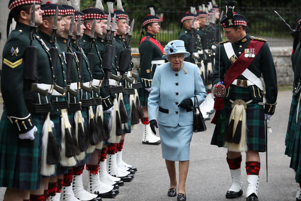 Queen Elizabeth II inspects the Balaklava Company, 5 Battalion The Royal Regiment of Scotland at the gates at Balmoral, as she takes up summer residence at the castle. (Photo by Andrew Milligan/PA Images via Getty Images)