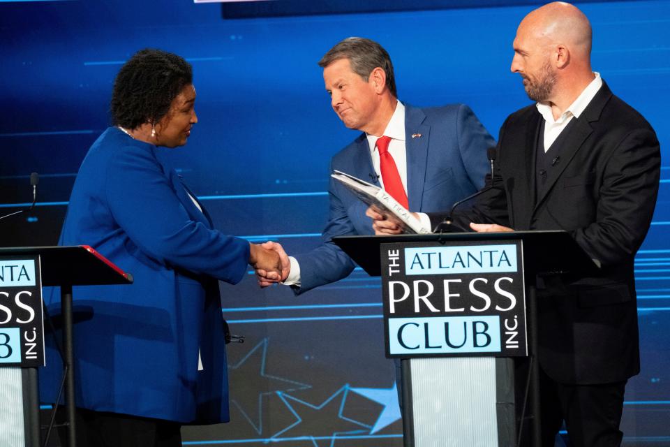 Democratic challenger Stacey Abrams, Georgia Republican Gov. Brian Kemp and Libertarian challenger Shane Hazel gather after their debate Monday night in Atlanta.