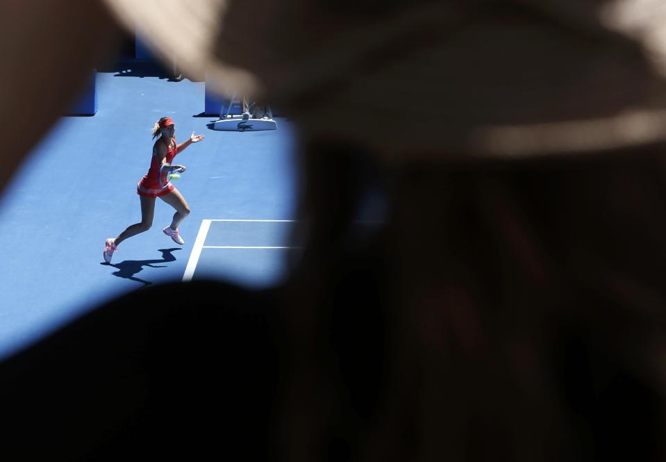 A spectator watches as Maria Sharapova of Russia hits a return to compatriot Ekaterina Makarova during their women's singles semi-final match at the Australian Open 2015 tennis tournament in Melbourne January 29, 2015. REUTERS/Brandon Malone (AUSTRALIA - Tags: SPORT TENNIS)