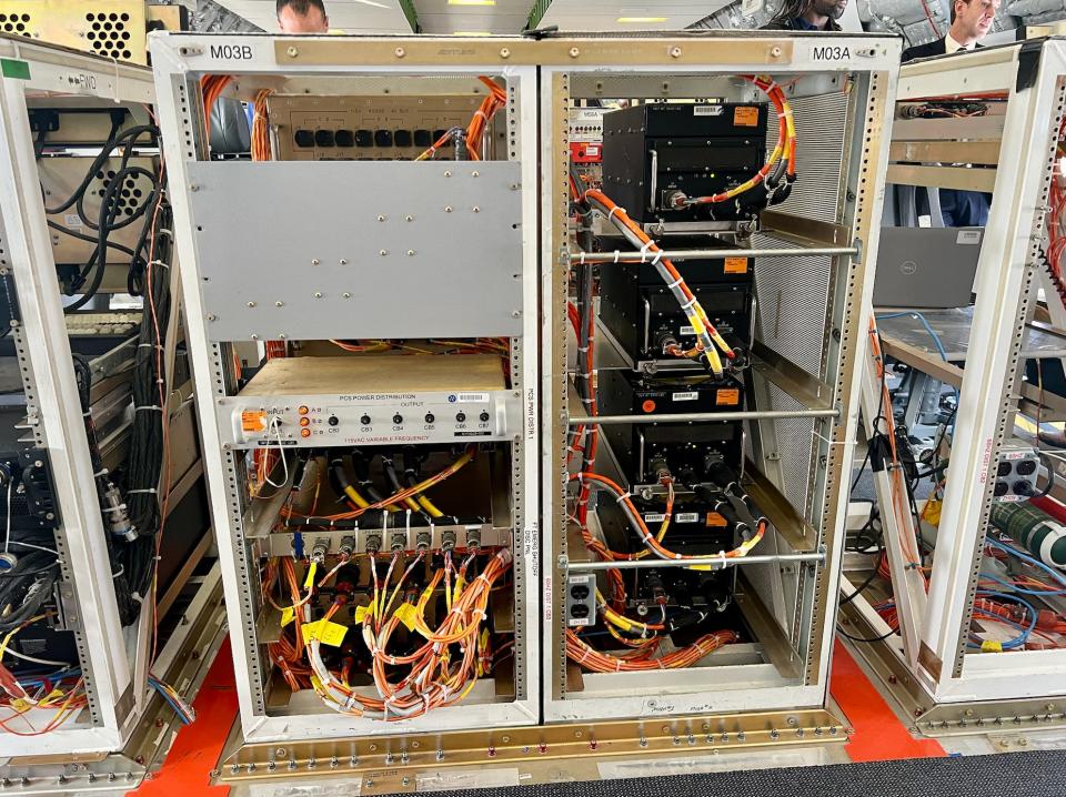 The computer systems with orange and gray wiring.