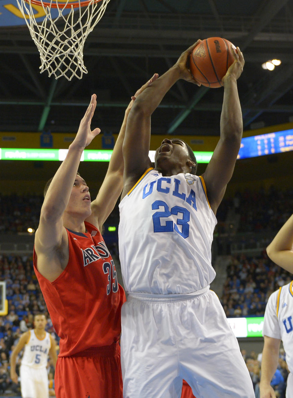 UCLA center Tony Parker, right, shoots as Arizona center Kaleb Tarczewski defends during the first half of an NCAA college basketball game on Thursday, Jan. 9, 2014, in Los Angeles. (AP Photo/Mark J. Terrill)