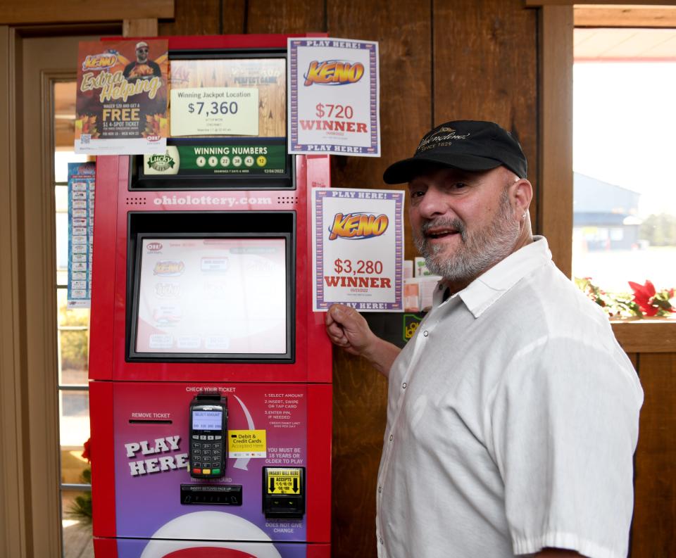 Mike Sylvester, owner of Hide-A-Way Buffalo Grill in Canton, stands by a sports betting kiosk. The restaurant and bar is among roughly a thousand businesses in Ohio licensed to offer sports betting at self-service or clerk-operated terminals starting Jan. 1.