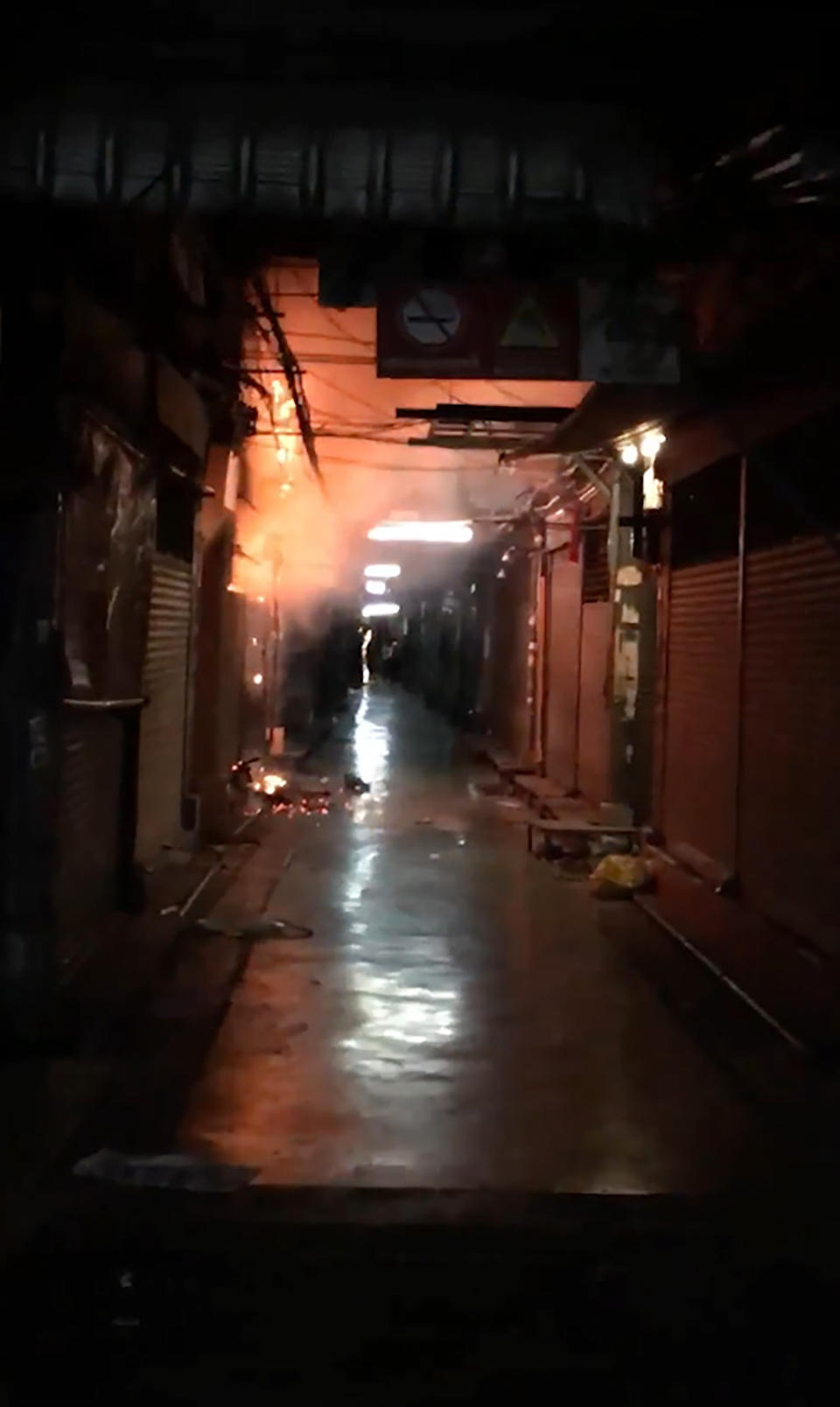 This Sunday, June 2, 2019 image taken from video provided by Younes Parvin shows a fire at Bangkok's Chatuchak weekend market, Thailand. Thai authorities are investigating an after-hours fire that roared through Chatuchak market, destroying dozens of the small shops crammed inside one of Asia's most popular bazaars. (Younes Parvin via AP Photo)