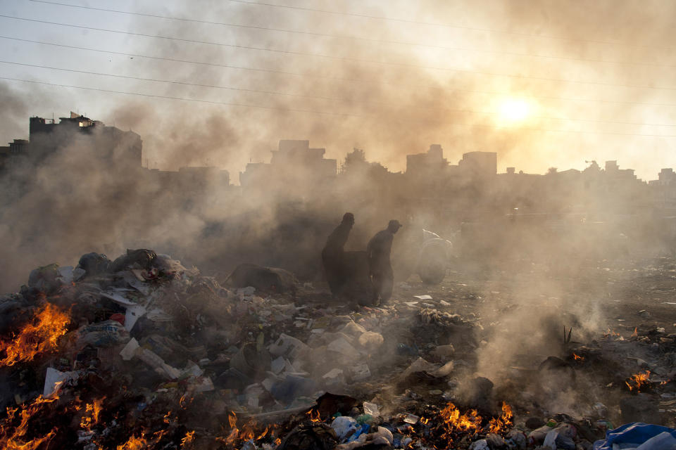 <p>Afghan refugees collect recyclable items from a a heap of garbage to earn their livings, Jan. 28, 2015. (AP Photo/Shakil Adil) </p>