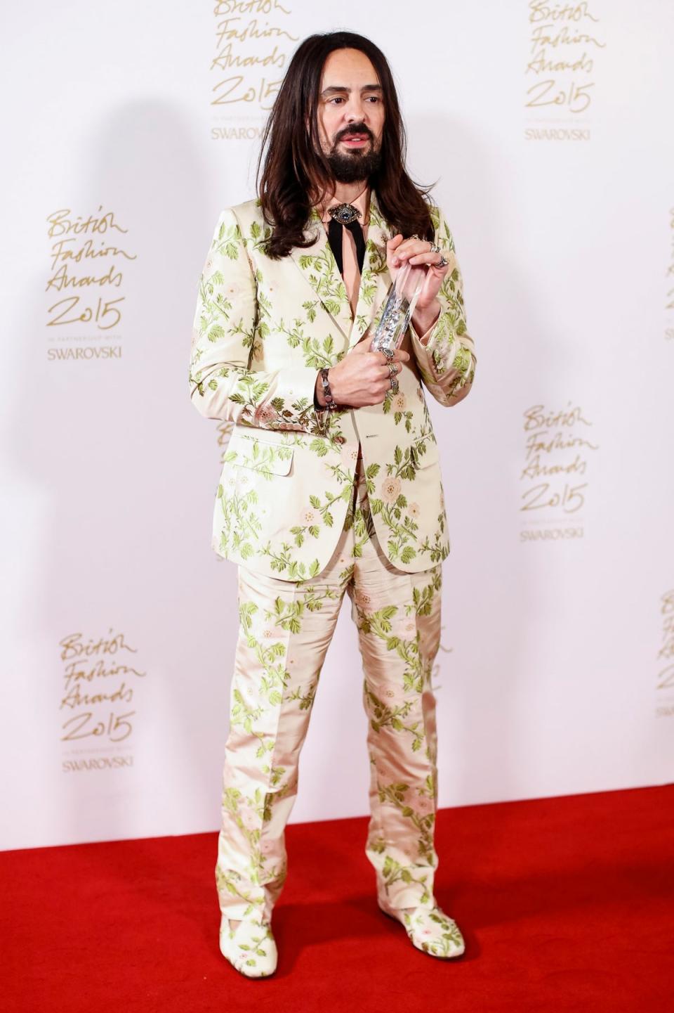 Italian fashion designer Alessandro Michele poses for pictures with his 