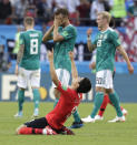 FILE - In this file photo dated Wednesday, June 27, 2018, Germany's players walk off the pitch as South Korea's Ju Se-jong, front, celebrates after their 2018 soccer World Cup in the Kazan Arena in Kazan, Russia. Germany did not progress out of the group stage and were ejected from the World Cup. German national soccer team head coach Joachim Loew was summoned to address FIFA’s World Cup coaches’ debrief in London Sunday Sept. 23, 2018, to explain Germany's ignominious elimination from the World Cup in Russia, “After such a long time at the top,” Loew said Sunday, “we were missing the last percent, the fire, the passion, and this greed to win a title no matter what.” (AP Photo/Lee Jin-man, FILE)