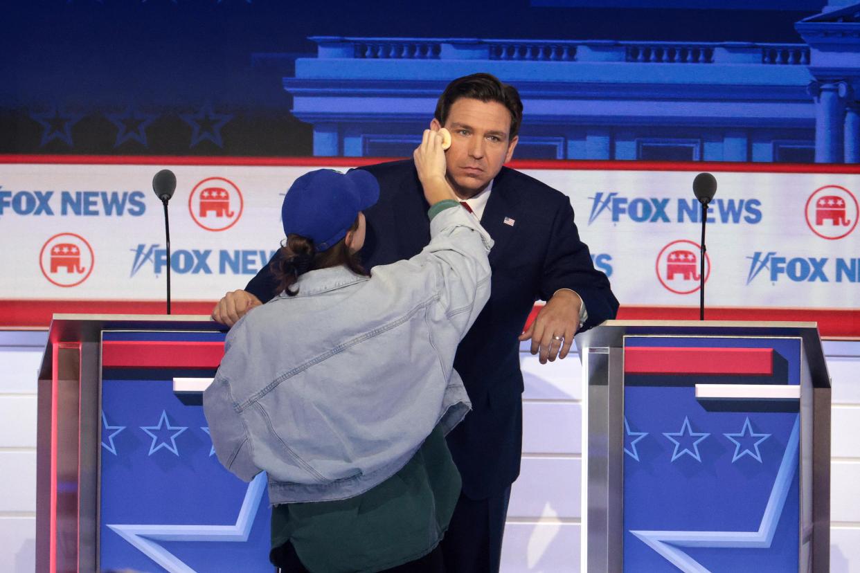 Florida Gov. Ron DeSantis has his makeup touched up during a break in the first debate of the GOP primary season.