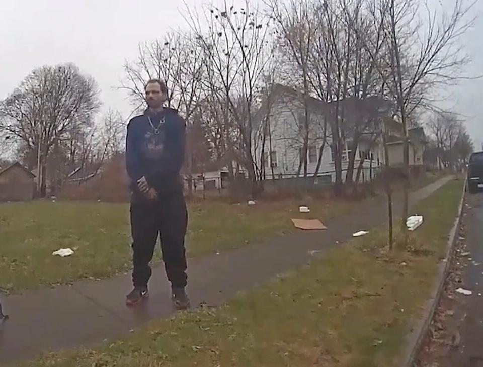 Todd Novick stands on Murray Street on Christmas Eve 2023, answering questions from a police officer. Police shot him in the back as he ran away from this sidewalk after they say he pulled a BB gun from his pocket. As he was handcuffed, Novick tried to explain why he had pulled the BB gun, new video footage shows. "I was trying to put it down. I'm sorry."