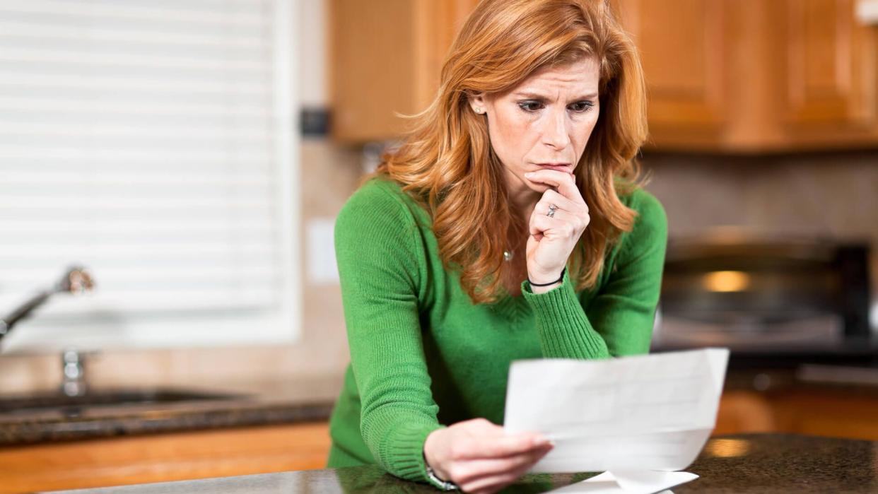 Worried woman reading letter[url=/search/lightbox/4698108][IMG]http://farm4.