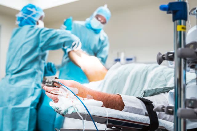 <p>Portra/Getty</p> Stock photo of patient lying on operation room bed