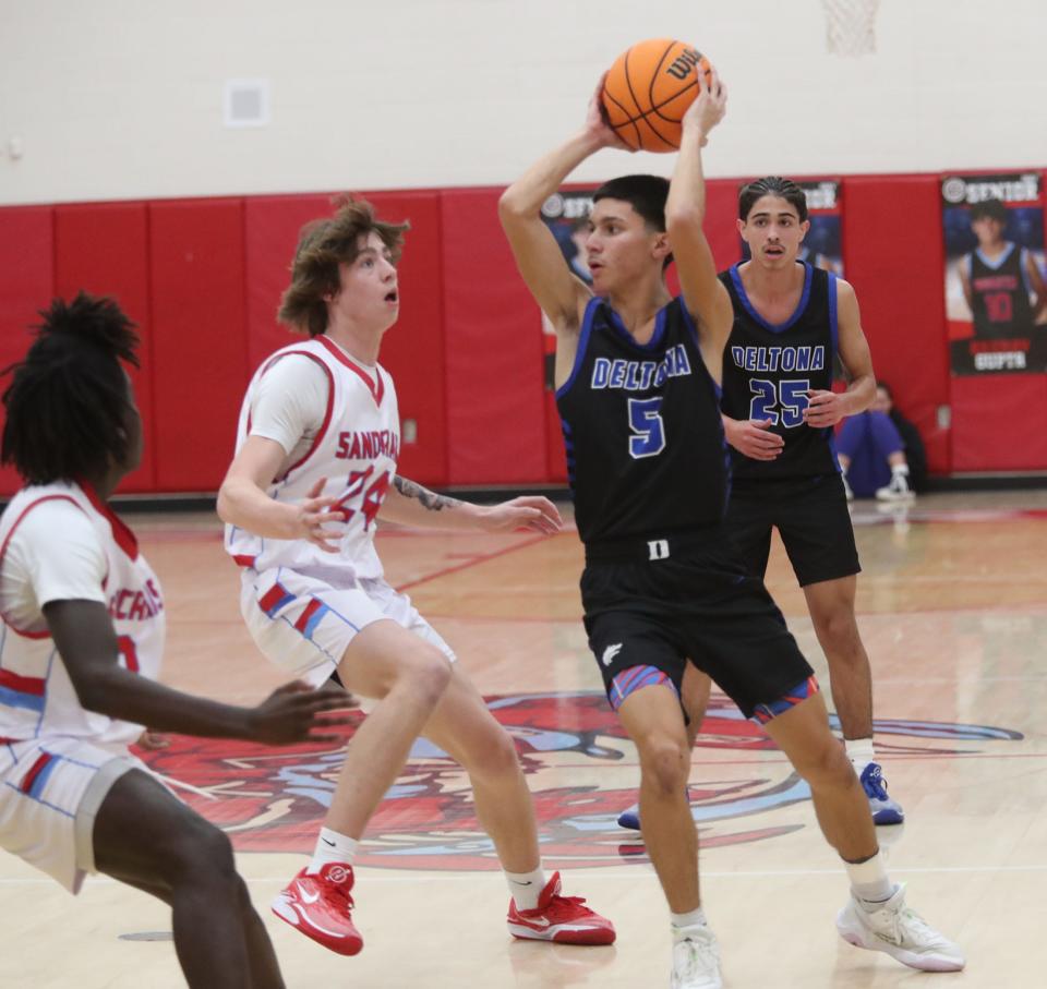 Deltona' High's Carlos Cerrud 35 looks to pass as Seabreeze High's Tyler Bogdarowicz #24 covers, Friday January 5, 2024 in Ormond Beach.