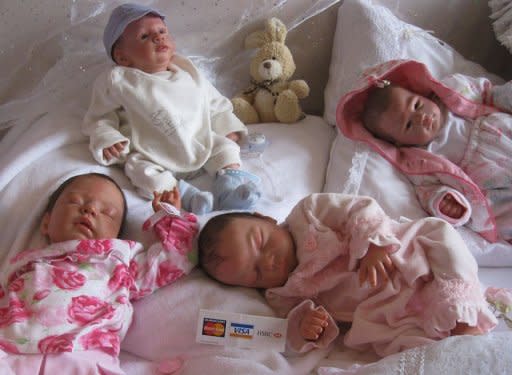 'Reborn babies', dolls which are made to look just like real babies, are displayed at the reborn babies fair in Brentwood, east of London, in February 2011. Weighing five kilos, with perfectly combed hair and her eyes closed in sleep, Abby looks like a baby girl. But she is a doll, adopted by a grieving mother to help come to terms with the loss of a child