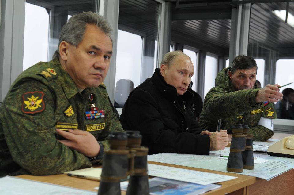 Russian President Vladimir Putin, center, and Defense Minister Sergei Shoigu, left, and the Chief of Gen. Ivan Buvaltsev, right, watch a military exercise near St.Petersburg, Russia, Monday, March 3, 2014. Putin has sought and quickly got the Russian parliament's permission to use the Russian military in Ukraine. (AP Photo/RIA-Novosti, Mikhail Klimentyev, Presidential Press Service)