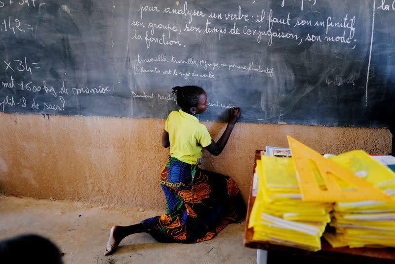 FILE PHOTO: A girl who fled from attacks of armed militants in Sahel region attends a class in Dori