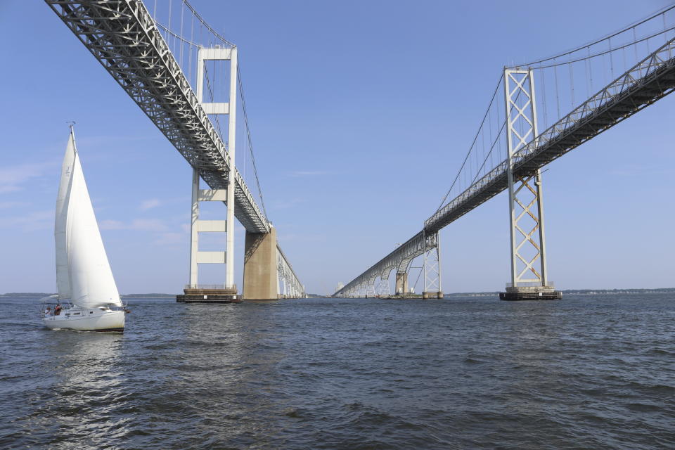 A boat sails on the Chesapeake Bay under the Bay Bridge near Stevensville, Md., on Sunday, Aug. 20, 2023. The overall health of the Chesapeake Bay has received its highest grade since 2002 in an annual report released on Tuesday, July, 9, 2024: a C-plus. (AP Photo/Brian Witte)