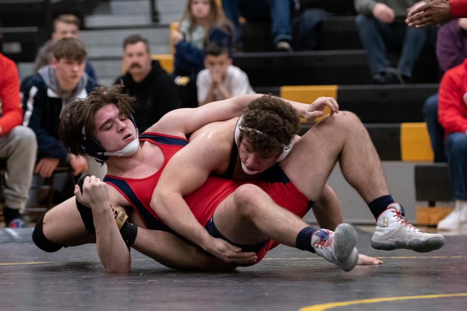 Central Bucks West's Carl DiGiorgio (back) won the 215-pound title at Saturday's PIAA District One Class 3A Southeast Regional Tournament while Central Bucks East's Quinn Collins (front) won at 189 pounds.