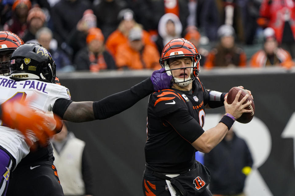 Baltimore Ravens linebacker Jason Pierre-Paul (4) gets his hand on the face mask of Cincinnati Bengals quarterback Joe Burrow (9) in the second half of an NFL football game in Cincinnati, Sunday, Jan. 8, 2023. (AP Photo/Joshua A. Bickel)