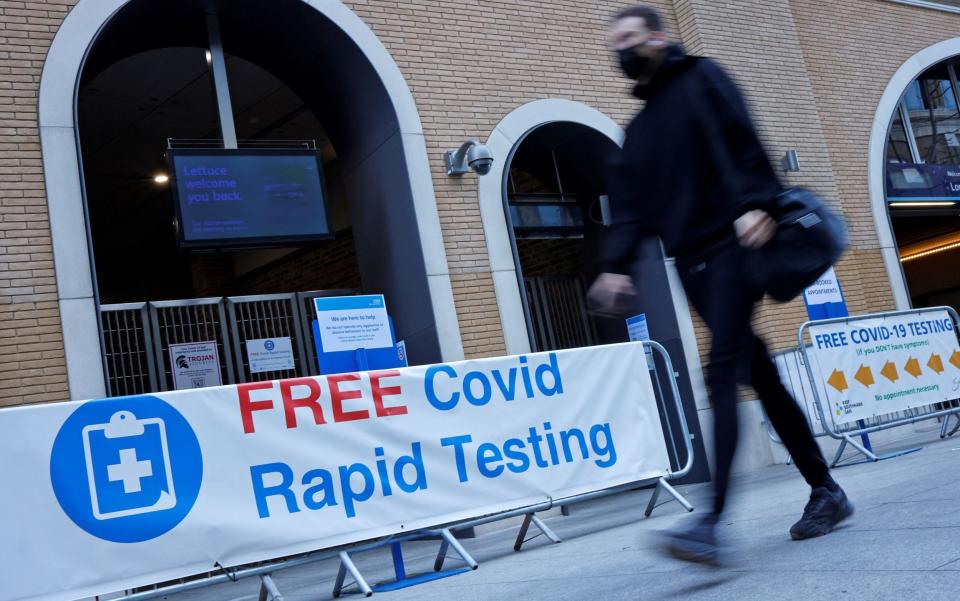 A man walks past a lateral flow testing centre at London Bridge - Tolga Akmen/AFP