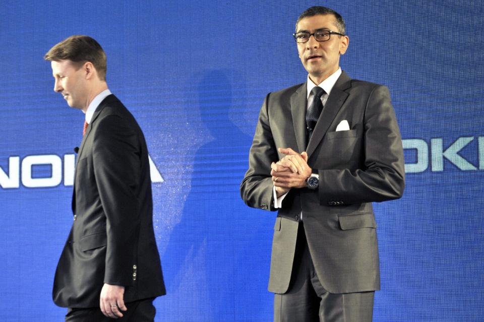 New President and Chief Executive Officer of Nokia Rajeev Suri, right, speaks beside Chairman of the Board of Directors and interim CEO of Nokia Risto Siilasmaa during the press conference where Nokia announced first quarter earnings in Espoo, Finland Tuesday, April 29, 2014. Nokia Corp. says it continued to be hit by fierce competition in the first-quarter with a 30 percent fall in sales of mobile devices, the troubled unit it sold to Microsoft last week. (AP Photo/Lehtikuva, Heikki Saukkomaa) FINLAND OUT, NO SALES