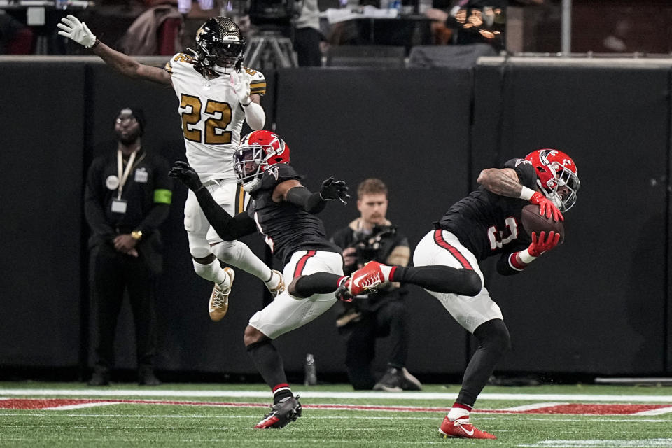 Atlanta Falcons safety Jessie Bates III (3) intercepts the ball intended for New Orleans Saints wide receiver Rashid Shaheed (22) during the first half of an NFL football game, Sunday, Nov. 26, 2023, in Atlanta. Bates ran the ball 92-yards for a touchdown. (AP Photo/Brynn Anderson)