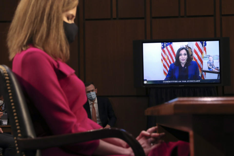 Democratic vice presidential candidate Sen. Kamala Harris, D-Calif., speaks during the confirmation hearing for Supreme Court nominee Amy Coney Barrett, left, at the Senate Judiciary Committee on Capitol Hill in Washington, Monday, Oct. 12, 2020. (Leah Millis/Pool via AP)