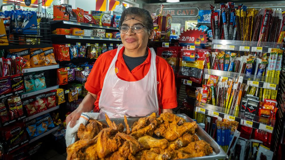 At Market Express, formerly Quik Shoppe, in Charlotte, Carolina, Medley photographed Marta Miranda, who had been frying chicken for 18 years. - Kate Medley