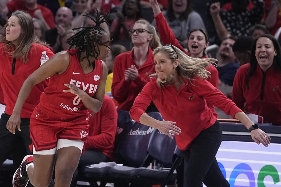 Indiana Fever coach Christie Sides celebrates a 3-point shot by Kelsey Mitchell (0) against the Connecticut Sun during the first half of a WNBA basketball game Friday, May 19, 2023, in Indianapolis. (AP Photo/Darron Cummings)