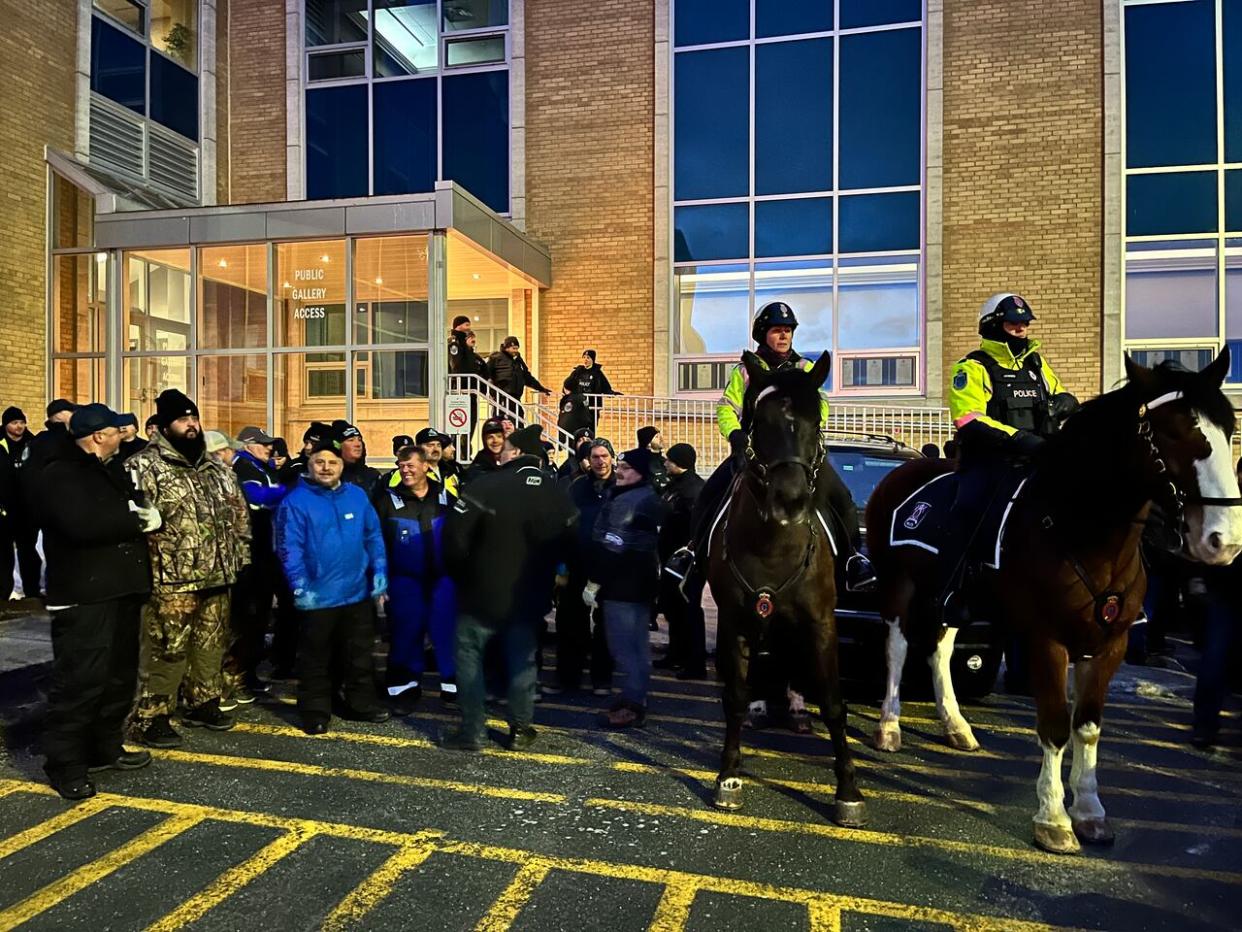 Officers on horseback patrolled outside Confederation Building in St. John's on Wednesday morning as fish harvesters protested against the government on the day the provincial budget is set to be unveiled. (Terry Roberts/CBC - image credit)