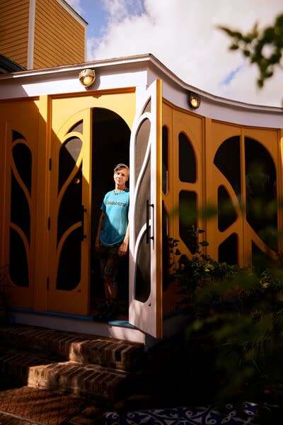 Actor, writer, and producer John Cameron Mitchell stands at the back door to his home in the Bywater section of New Orleans, a city he felt drawn to as more and more theater friends moved there and he began to seek a laid-back alternative to New York. But not entirely laid-back: The house, formerly owned by a mystic religious society, includes a 45-foot ballroom complete with stage, where John hosts parties and performances. 