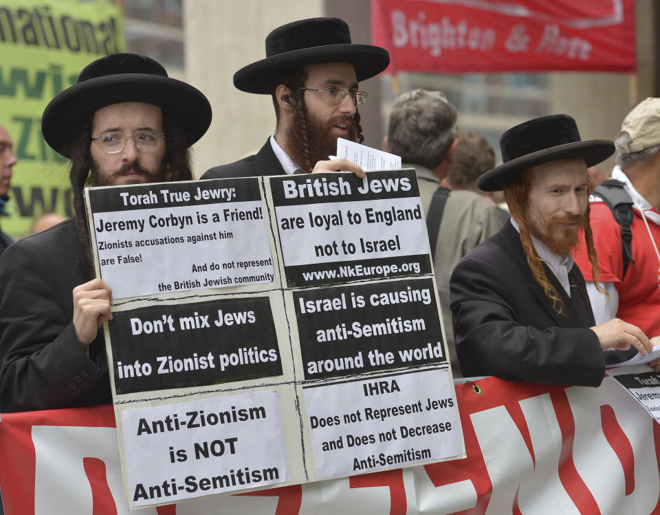 Activists outside a meeting of the Labour National Executive Committee in London, which is debating their adoption of a definition of anti-Semitism, Tuesday Sept. 4, 2018, which has been the subject of a bitter row within the party over recent months. Labour's ruling body will decide Tuesday whether to fully adopt an international definition of anti-Semitism. (Nick Ansell/PA via AP)