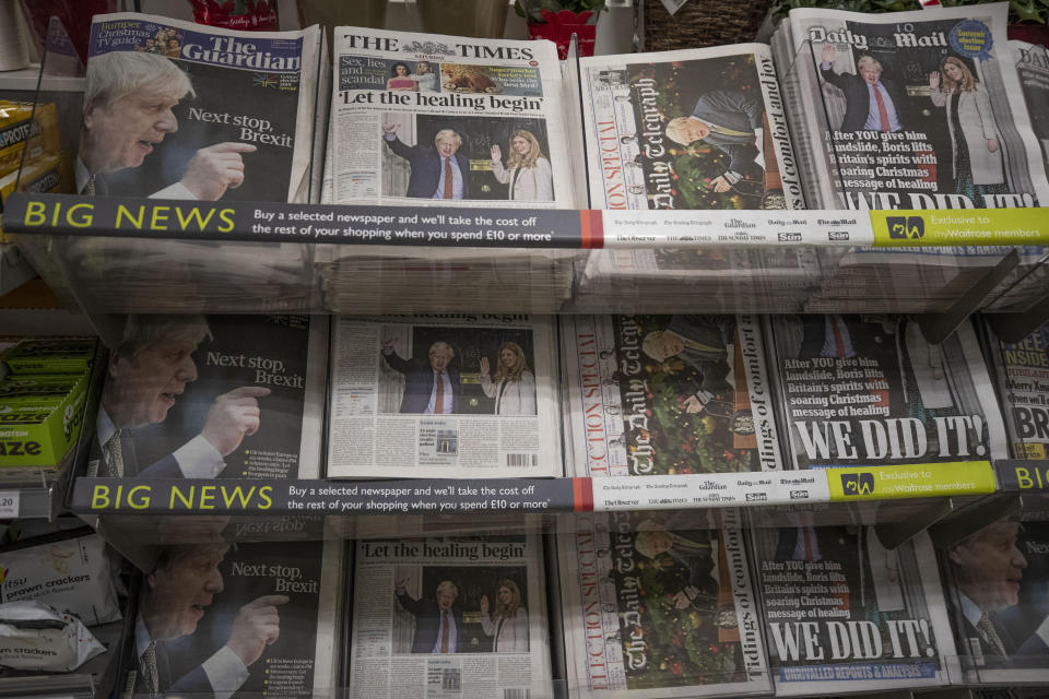 Newspapers sit on display for sale with their front pages reporting on the general election in a supermarket in south west London, Saturday, Dec. 14, 2019. Prime Minister Boris Johnson pledged Friday to heal Britain's divisions over Brexit after his gamble on early elections rewarded him with a commanding majority in Parliament and a new mandate to take his country out of the European Union at the end of January. (AP Photo/Matt Dunham)
