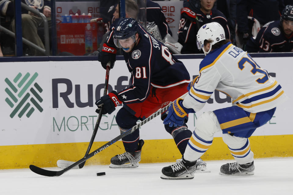 Columbus Blue Jackets' Stanislav Svozil, left, looks for an open pass as Buffalo Sabres' Kale Clague defends during the second period of an NHL hockey game Friday, April 14, 2023, in Columbus, Ohio. (AP Photo/Jay LaPrete)
