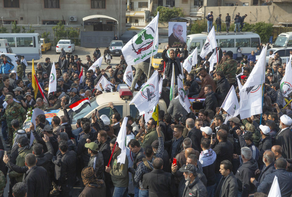 Mourners march during the funeral of Iran's top general Qassem Soleimani, 62, Abu Mahdi al-Muhandis, deputy commander of Iran-backed militias in Iraq known as the Popular Mobilization Forces and fellow militant leaders, in Baghdad, Iraq, Saturday, Jan. 4, 2020. Thousands of mourners chanting "America is the Great Satan" marched in a funeral procession Saturday through Baghdad for Iran's top general and Iraqi militant leaders, who were killed in a U.S. airstrike. (AP Photo/Nasser Nasser)
