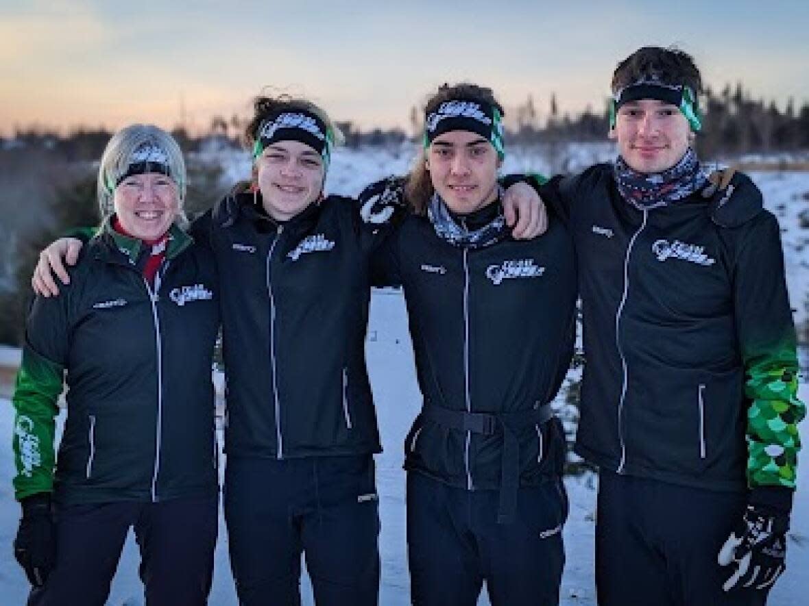 Team P.E.I.'s Judy Hale with athletes Matthew MacNeill, Fidel Wendt and Hudson Haltli at the Brookvale Nordic Centre before practice. The three will be competing in both cross-country skiing and biathlon later this month.   (Shane Hennessey/CBC  - image credit)