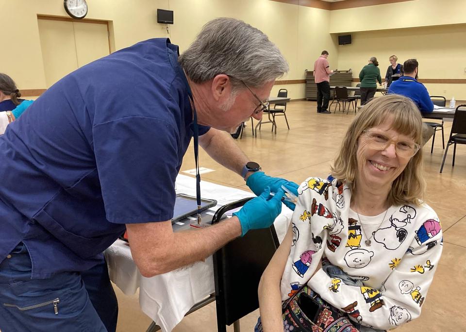 Dr. Tim Ward, a volunteer with the Northwest Pennsylvania Medical Reserve Corps, injects Mary Brosius, 70, of Harborcreek Township, with hepatitis A vaccine during a clinic Feb. 27 at the Perry Hi-Way Hose Co. Social Hall, 8281 Oliver Road, Summit Township.
