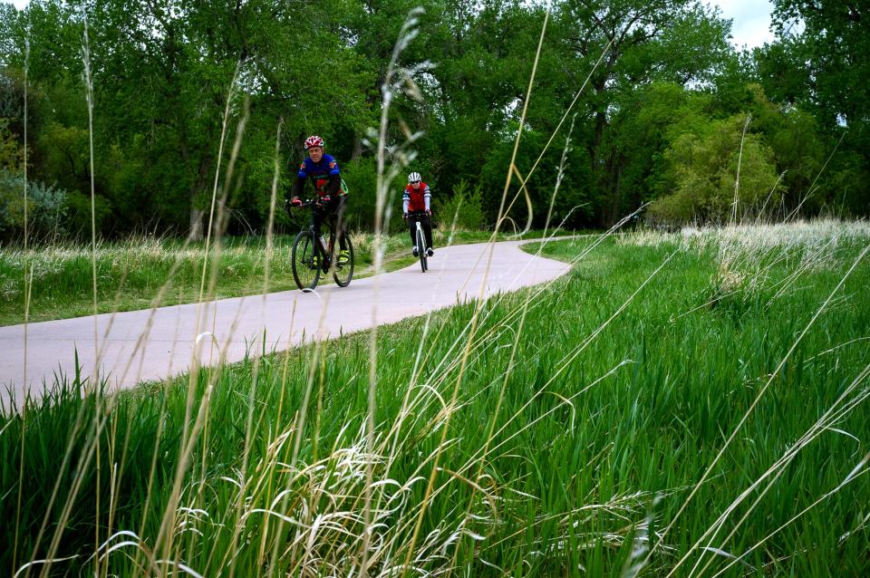 A pair of bikers make their way down the Poudre Trail in Fort Collins on May 24. Larimer County and the town of Timnath received a grant from Colorado Parks and Wildlife to construct the remaining 1-mile segment of the Poudre Trail between Timnath and Windsor.